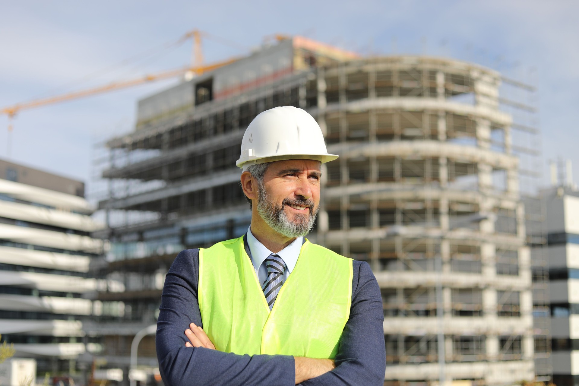 Senior manager - portrait in front of an office building under construction
